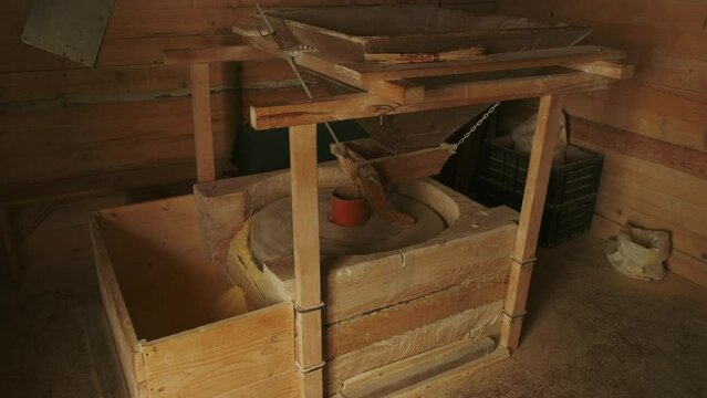 Working old water powered grist mill made of stones and wood, 4k