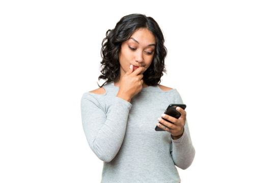 Young Argentinian woman over isolated background thinking and sending a message