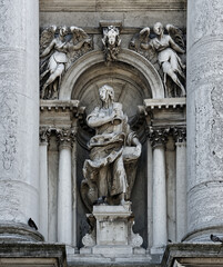Fototapeta premium Statues of John on facade of Basilica Di Santa Maria Della Salute Roman Catholic church in Venice, Italy