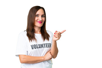 Middle age volunteer woman over isolated chroma key background pointing finger to the side