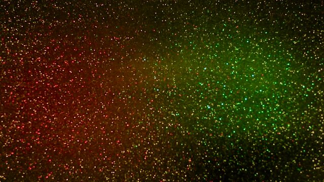 Spots of light of different colors appear on a dark background with flashing lights.