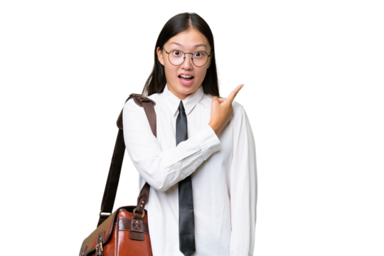 Young Asian business woman over isolated background surprised and pointing side