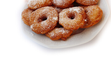 Homemade deep fried apple rings with batter sprinkled with powdered sugar on a  plate isolated on white backgrounds