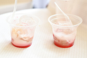 selendang mayang ice in a plastic cup. Selendang mayang ice is a drink that combines colorful chewy...