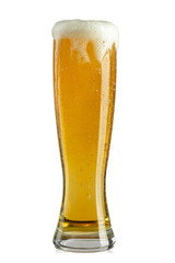 Glass of beer on white background. The foam of the drink pours over the glass.