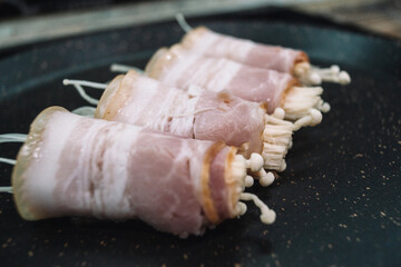 Bacon rolls in a frying pan