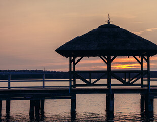 Evening view of tourist pier on Lake Narie in Kretowiny village, Warmia and Mazury region, Poland