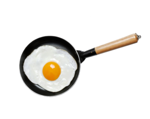 Fried egg yolk on frying pan isolated on transparent layered background.