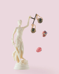 Heart and brain fall out of Lady Justice scales on isolated pastel pink background. Punishment...