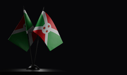 Small national flags of the Burundi on a black background