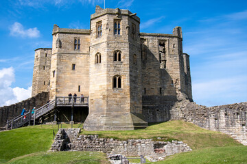 Fototapeta na wymiar Main keep at Warkworth Castle in Northumberland, UK, against a blue summer sky