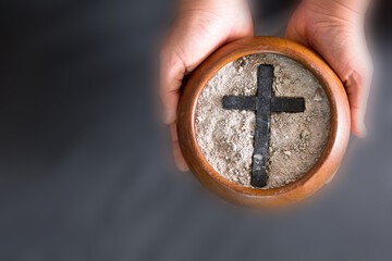 Ashes in hand are prepared for Christian festival of apostles. dust symbol of religion, sacrifice,...