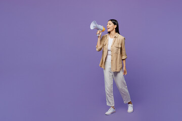 Full body shocked young latin woman wears light shirt casual clothes hold in hand megaphone scream announces discounts sale Hurry up isolated on plain pastel purple color background studio portrait.