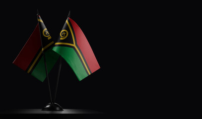 Small national flags of the Vanuatu on a black background