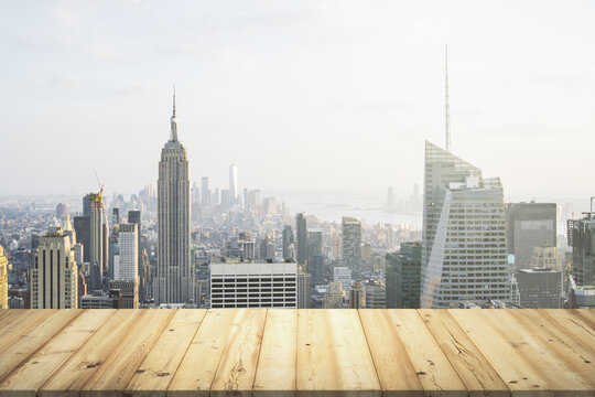 Wooden table top with beautiful New York skyline on background, mockup