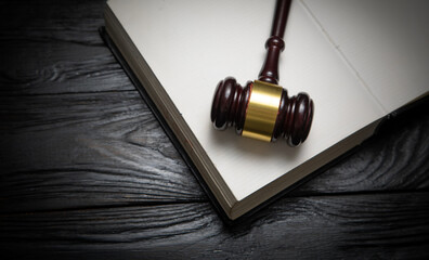 Judge gavel and book on the black table.