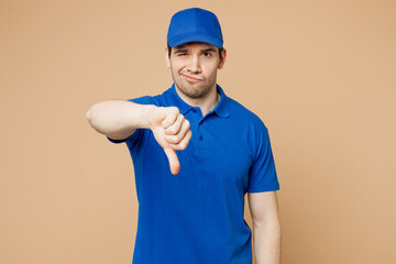 Professional sad delivery guy employee man wear blue cap t-shirt uniform workwear work as dealer...