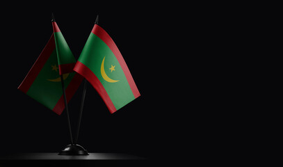 Small national flags of the Mauritania on a black background