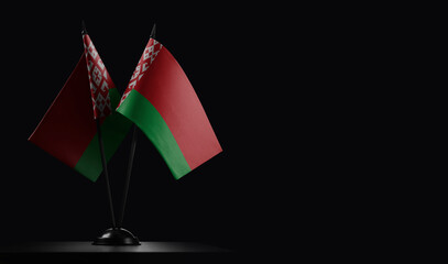 Small national flags of the Belarus on a black background