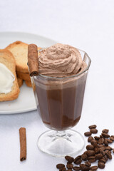 glass with mocaccino covered with chocolate cream, toasted on the side