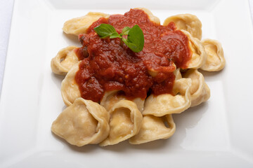 ravioli pasta on a plate with red tomato sauce