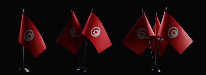Fototapeta na wymiar Small national flags of the Tunisia on a black background