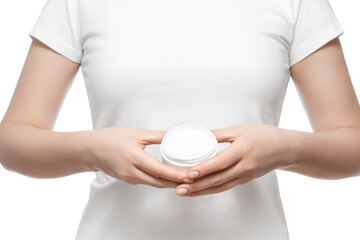 Cropped shot of a woman in white t-shirt holding a jar of hand cream, isolated on white. Well-groomed short natural nails.