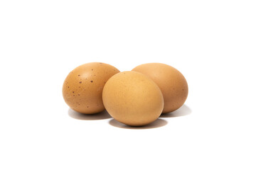 Three brown chicken eggs. Isolated on a white background. Vegetarian food concept.