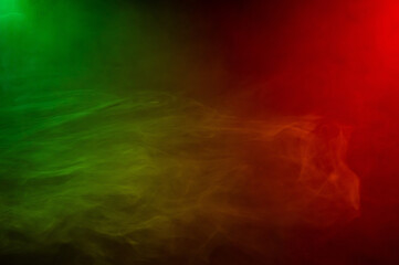 Obraz na płótnie Canvas Red yellow green smoke on a black background.