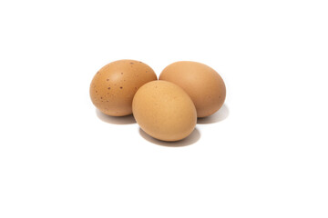 Three brown chicken eggs. Isolated on a white background. Vegetarian food concept.