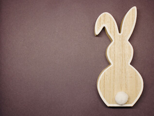 Wooden rabbit on ultimate purple color of the year 2022. right side, flat lay background. Copies space.