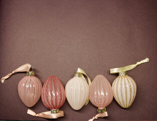 easter egg or eggs in 4 different pink colours on a purple background on the bottom side, colour of the year 2022, top view, copies space