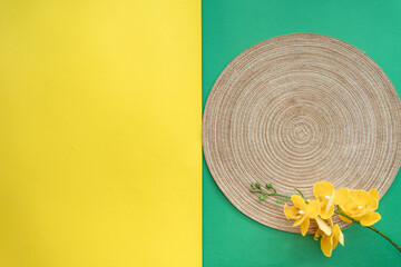 Western table setting with traditional table mat and dinnerware with green and yellow background....