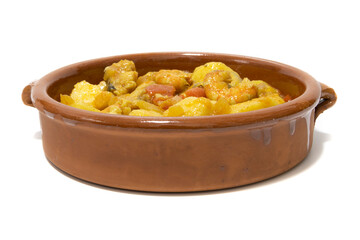 Potato stew with cod, served in a clay bowl. Isolated on white background. Spanish food concept.