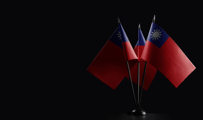 Small national flags of the Taiwan on a black background