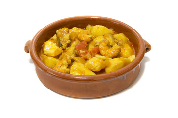 Potato stew with cod, served in a clay bowl. Isolated on white background. Spanish food concept.