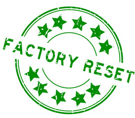 Grunge green factory reset word with star icon round rubber seal stamp on white background