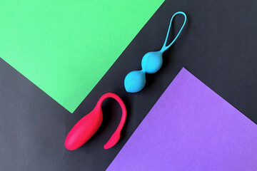 Two sex toys. Vibrator and geisha balls. Sex shop assortment. Flat lay