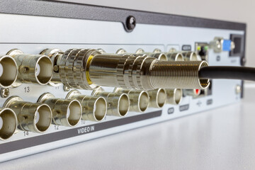 Close-up view on a digital video recorder on the part connectors with one bnc connector. Back panel.