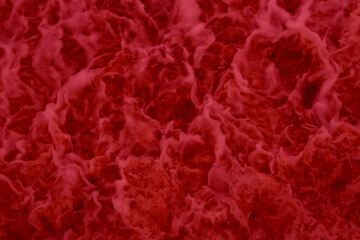 Unfocused abstract background . Multicolored foam with bubbles in the water. The texture of red foam. Blood-red background. Boiling blood.