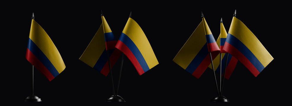 Small national flags of the Colombia on a black background