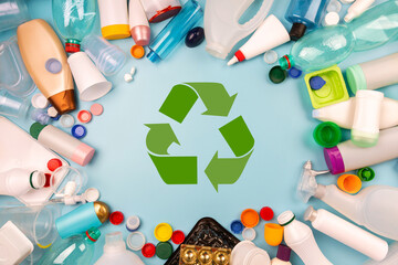 Separate collection of plastic garbage. PET, PP, HDPE, LDPE stuff for recycle on blue background....