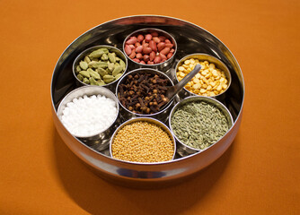 Indian spices box or Indian masala dabba on orange background