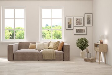 White living room with sofa and summer landscape in window. Scandinavian interior design. 3D illustration