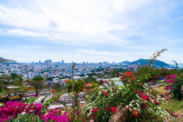 Morning in Vung Tau seen from above, with the most beautiful sea waves, coastline, streets, buidling, coconut trees and Tao Phung mountain in Vietnam. Travel concept.