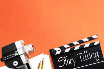 Story telling. text title on film slate or clapperboard and the old 8mm movie film camera for...