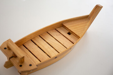 Close up shot of wooden boat sushi decoration. Japanese food 