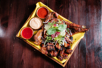 Beer snacks. Chips nuggets and chicken with sauce top view.