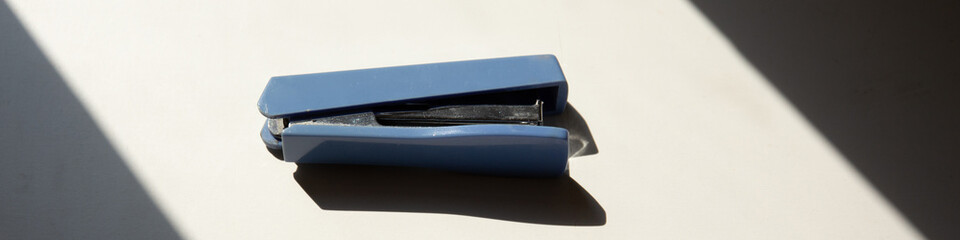 Close up of blue stapler on the table