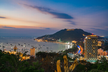 Fototapeta na wymiar Vung Tau city aerial view at night with the most beautiful sea waves, coastline. Vung Tau is the capital of the province since the province's founding and is the crude oil extraction center of Vietnam